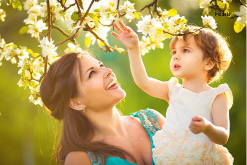 happy woman and child in the blooming spring garden-img-blog