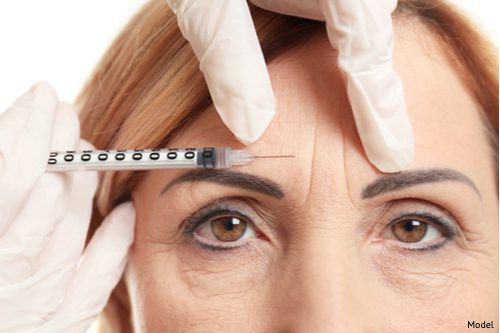 A woman with deep forehead wrinkles is receiving a BOTOX® Cosmetic treatment to help erase the fine lines and furrows.