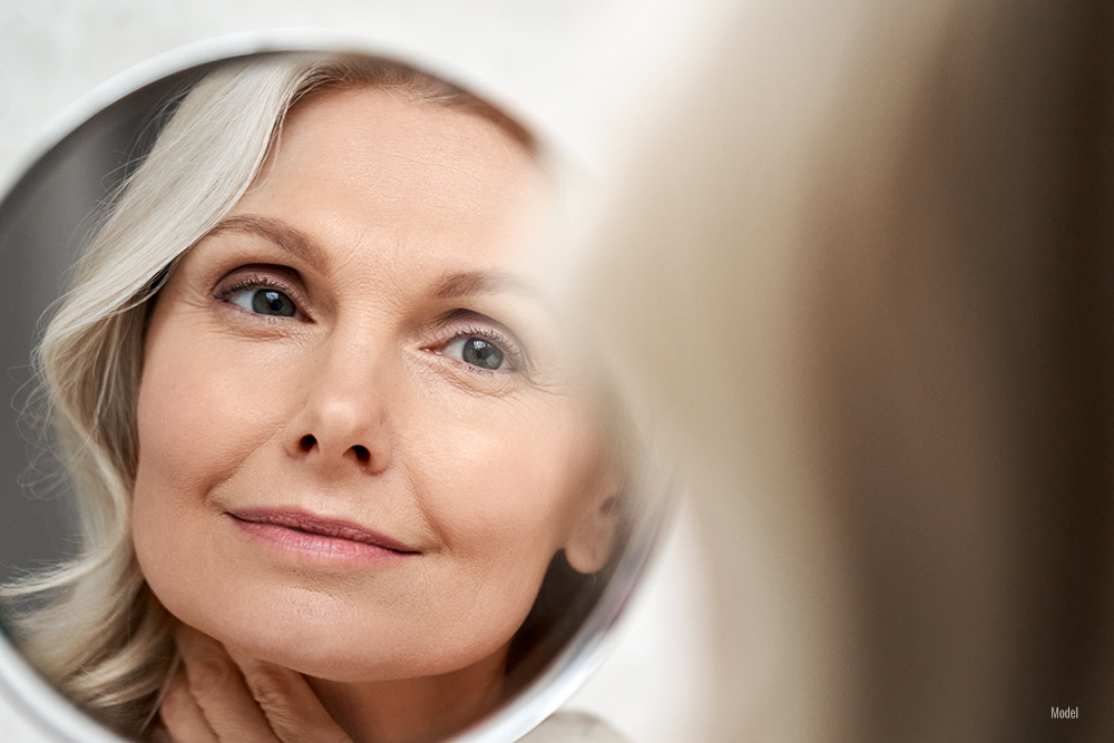 close up of middle-aged woman's face in the mirror