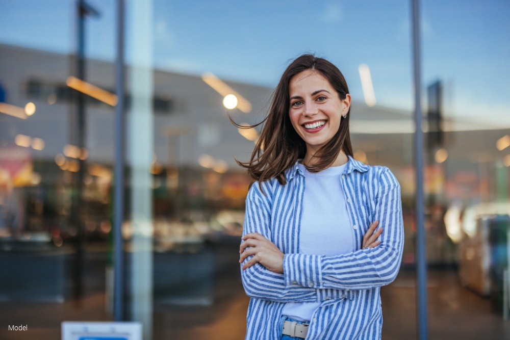 Woman in casual clothing in the street smiling looking at the camera